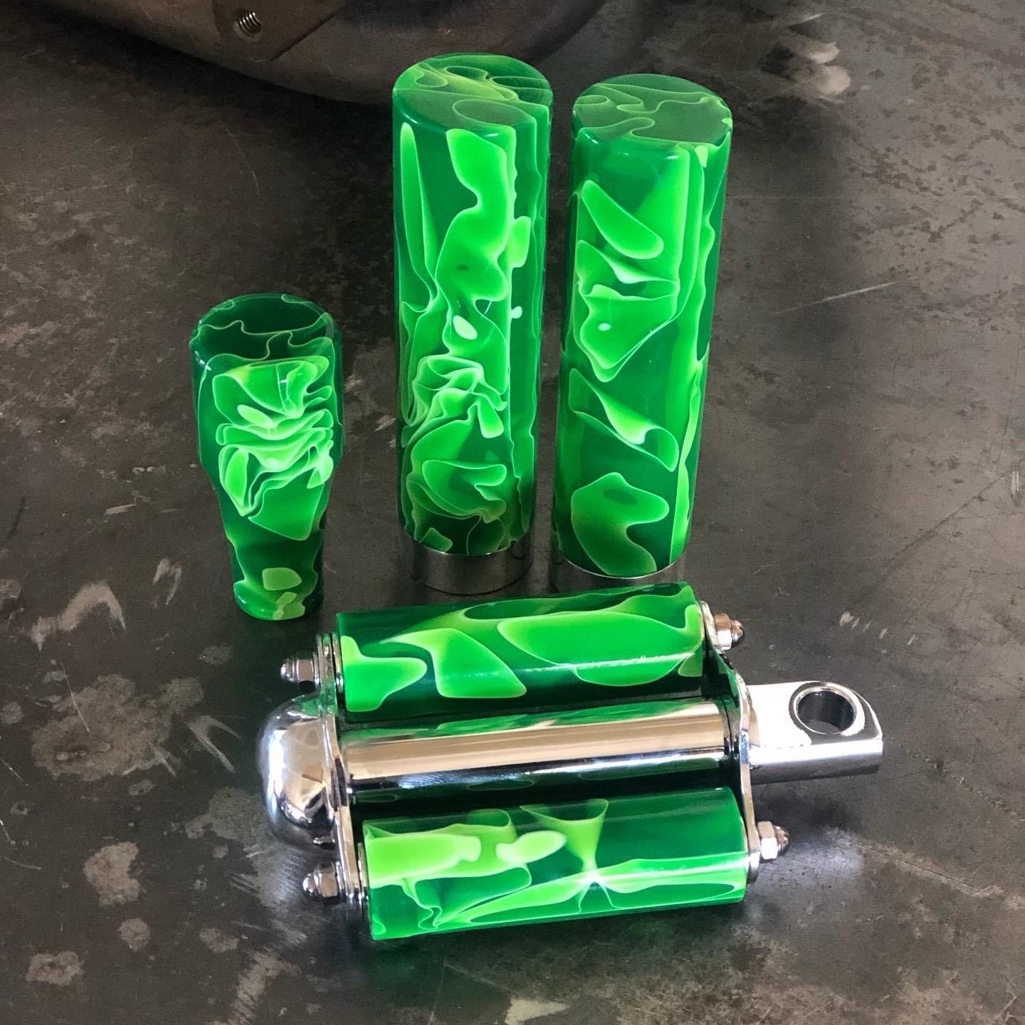 Green acrylic and metal grips, kicker pedal, and shift knob for motorcycle